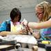 May Yang and Grace Battersby build an egg device during the Ann Arbor District Library Eggcellent Engineering on Saturday, July 6. Daniel Brenner I AnnArbor.com